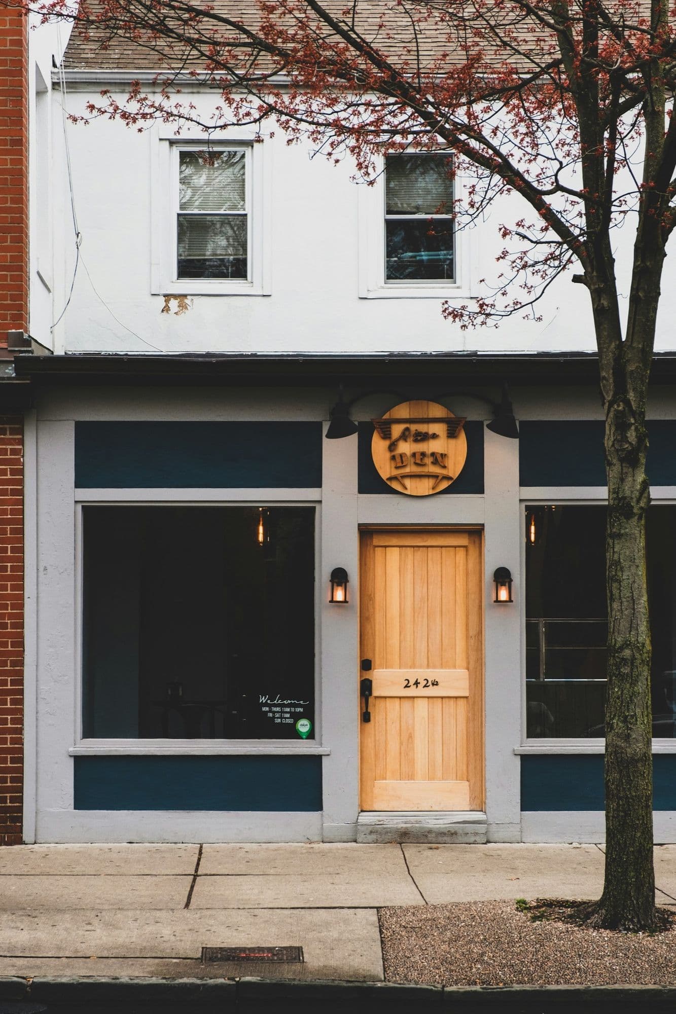A shopfront with a timber entrance door between two display windows